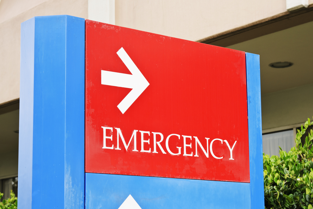 Common Causes of Burn Injuries - sign at the hospital points towards the emergency room entrance.